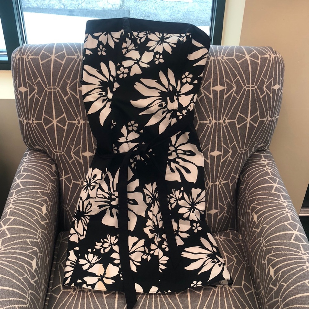 Used black and white dress does have a small stain do believe it will wash out